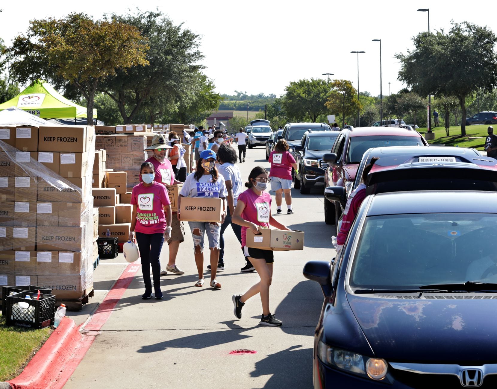 Volunteers with Minnie’s Food Pantry distribute free food at One Community Church in Plano, Texas, on Aug. 22, 2020. 
