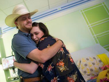 Singer-songwriter Cody Johnson, left, embraces Danielle Grey, 19, with a hug during a...