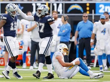 Dallas Cowboys linebacker Micah Parsons (11) is congratulated by defensive tackle Osa Odighizuwa (97) after his sack of Los Angeles Chargers quarterback Justin Herbert (right) during the fourth quarter at SoFi Stadium in Inglewood, California, Sunday, September 19, 2021. The Cowboys won, 20-17. (Tom Fox/The Dallas Morning News) 