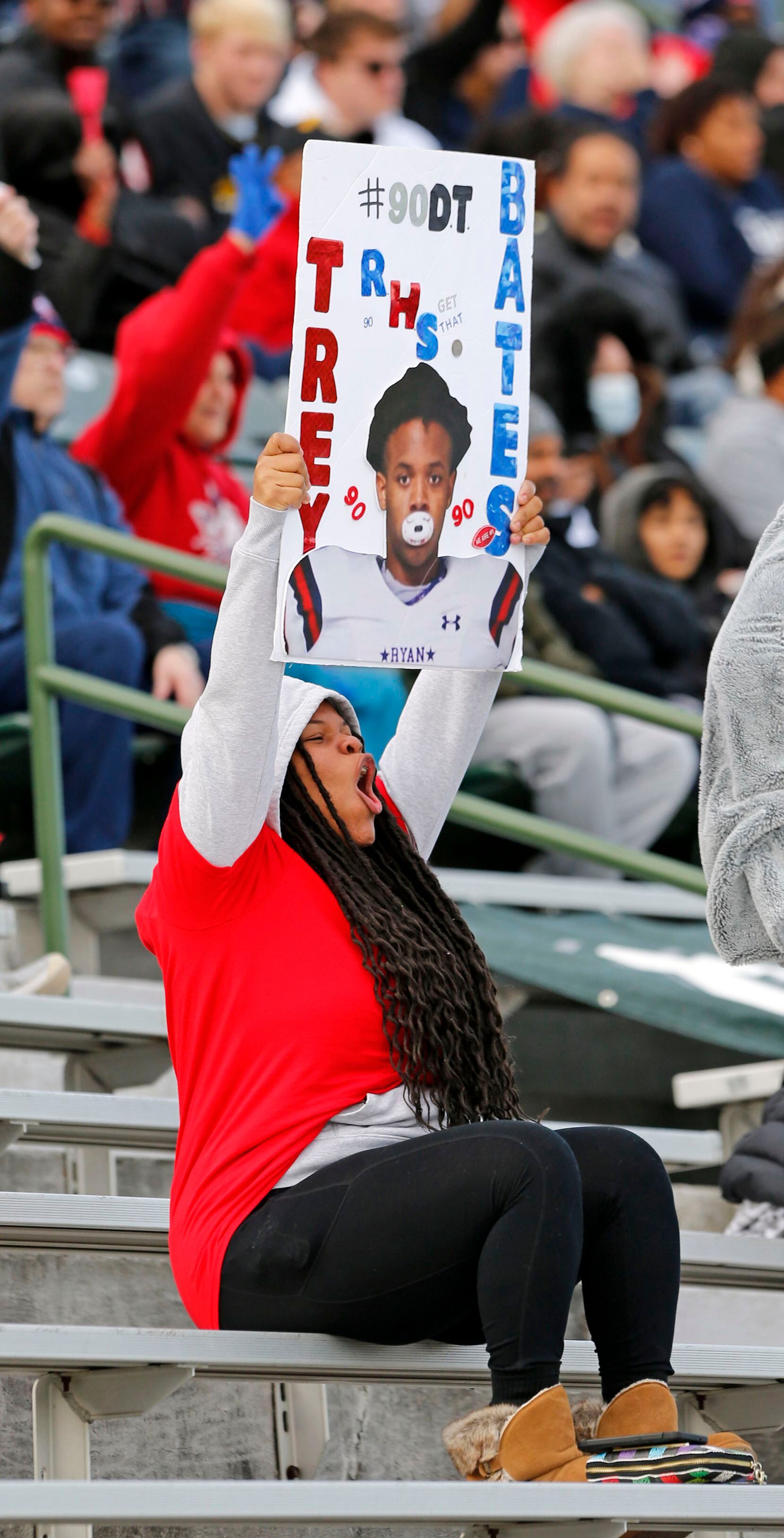 A Denton Ryan fan displays her favorite player during the first half of the Class 5A...