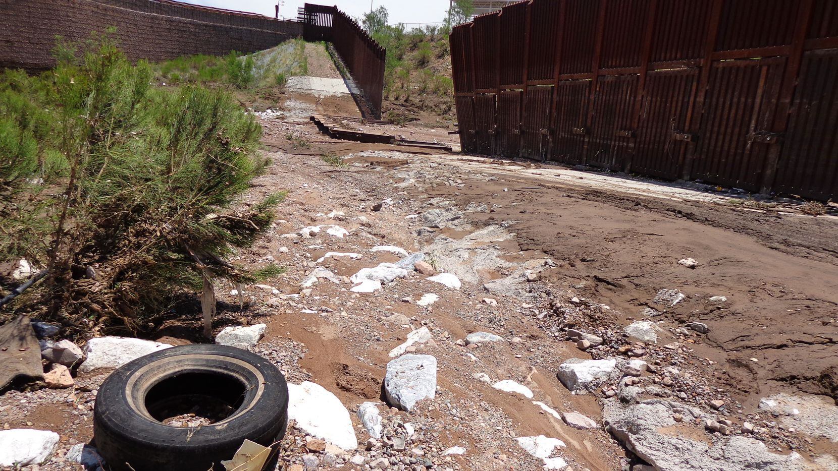 A section of fence lies collapsed just west of the Mariposa Port of Entry in Nogales, Ariz.,...