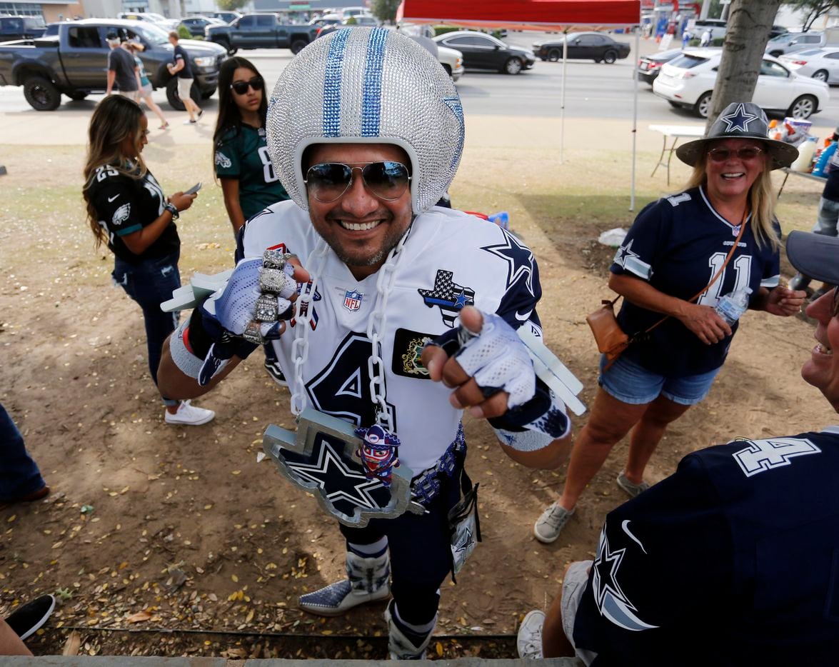 Dallas Cowboys fan Jaime Castro, of El Paso, displays his “bling”, while tailgating during...