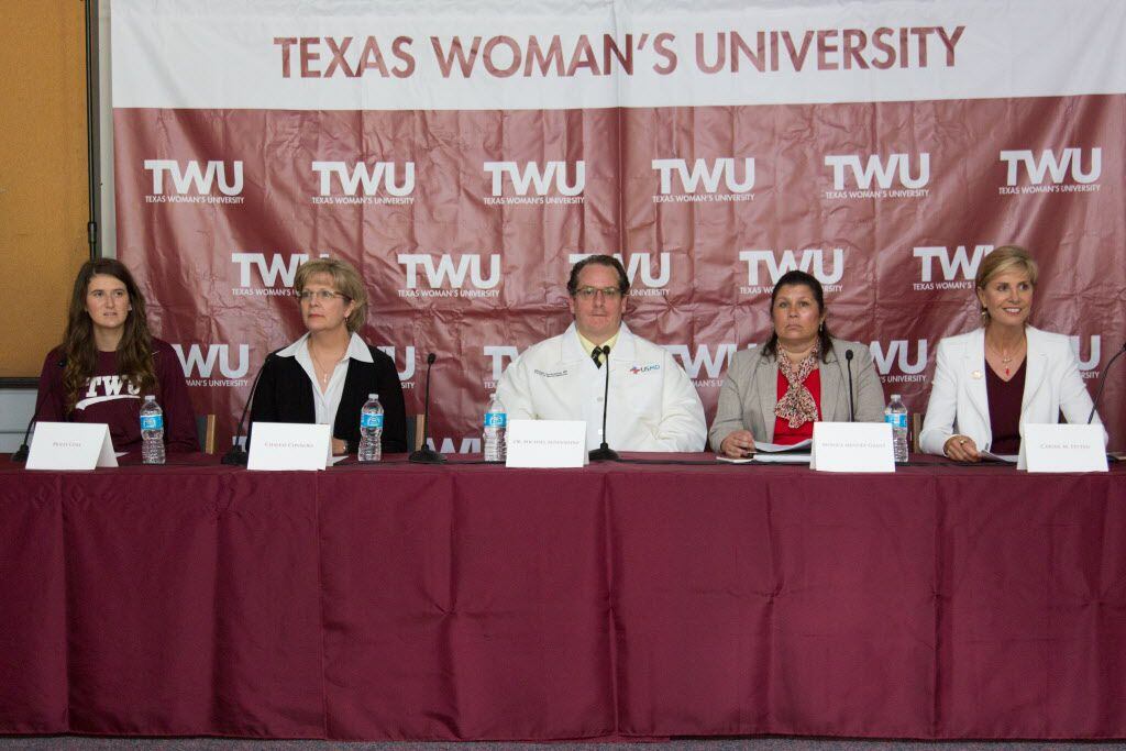 A panel of speakers at a press conference at Texas Women's University.  From left to right,...