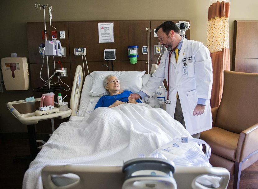 
Dr. Mark Casanova checks on a patient at Baylor University Medical Center in Dallas....