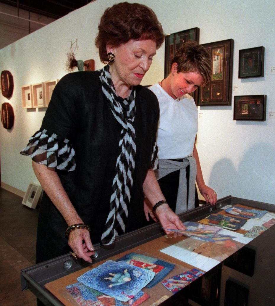 Edith Baker (left), longtime Dallas gallery owner, goes over some prints with her assistant Cidnee Patrick. 
