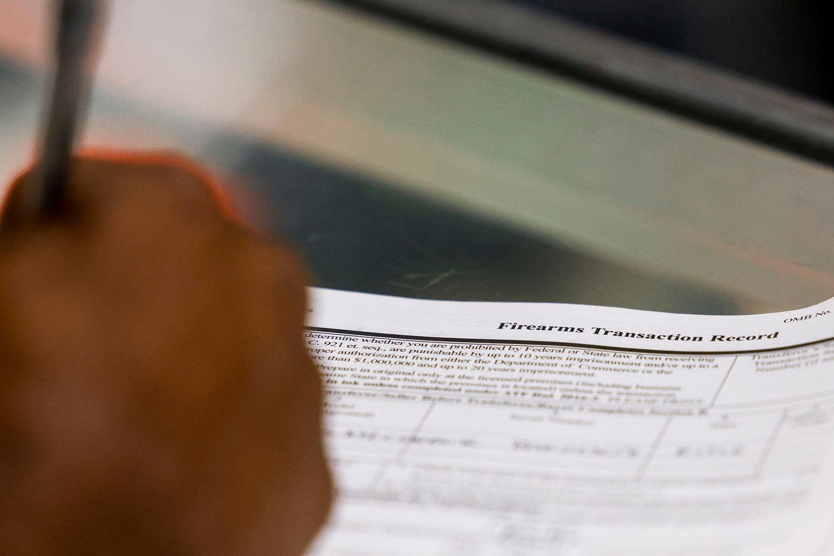 Brian Benford, 31, fills out ATF Form 4473, known as the Firearms Transaction Record, at...