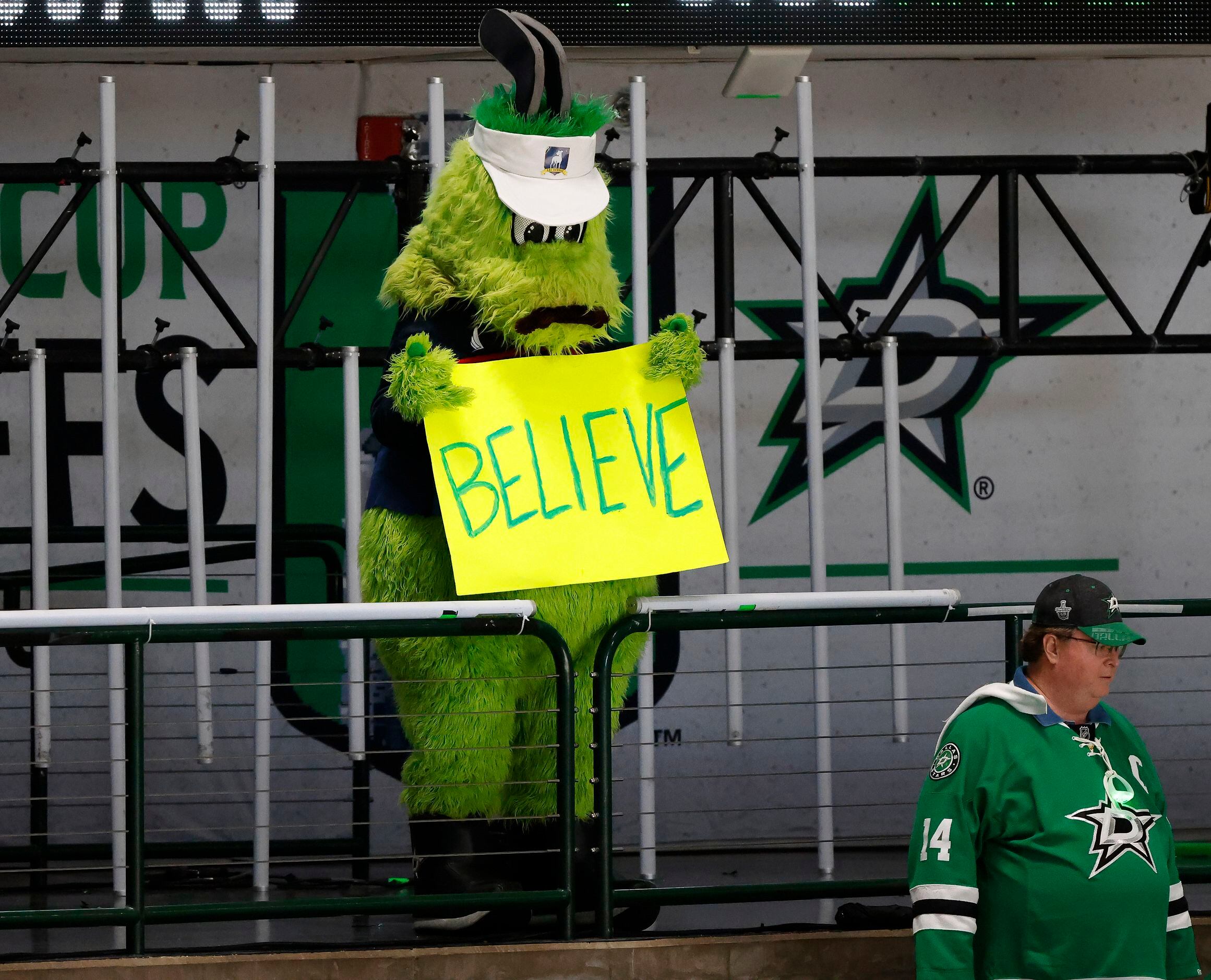 Dallas Stars mascot Victor E. Green hangs his head as he holds a ‘Believe’ in the closing...