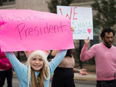 Leah Touchstone, 9, carries a sign during the Women's March on Saturday in Dallas. 