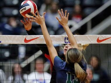 Colleyville Heritage High School's Reagan Engler (15) tips the volleyball past Reedy High...