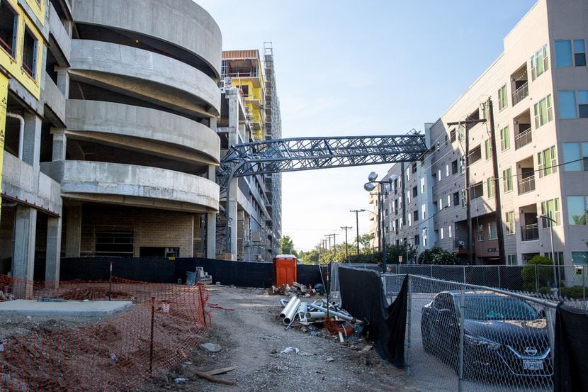 A construction crane remains broken above the Elan City Lights apartment complex in Dallas...