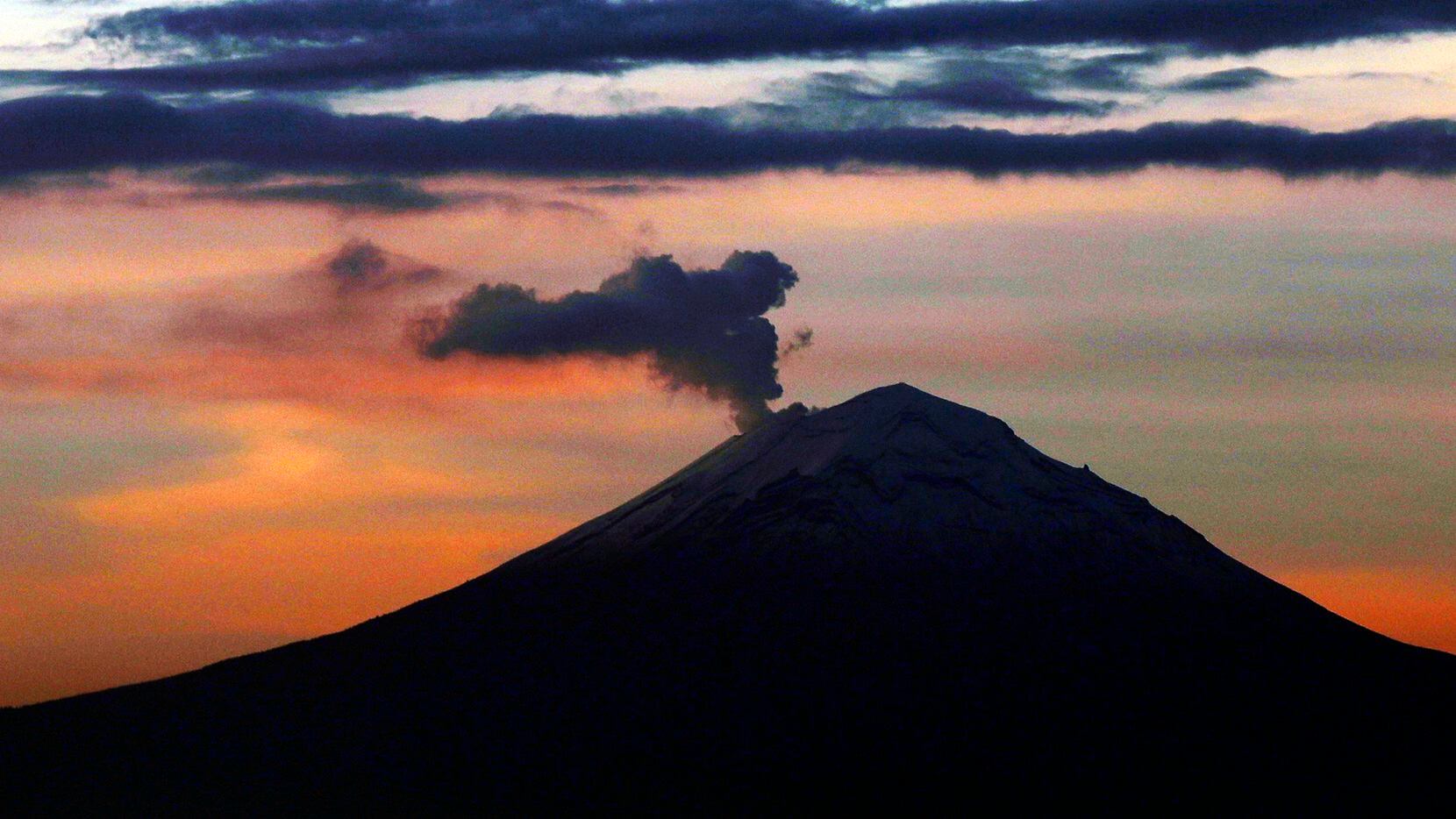 En esta fotografía de archivo se ve una columna de cenizas y vapor elevarse sobre el volcán...