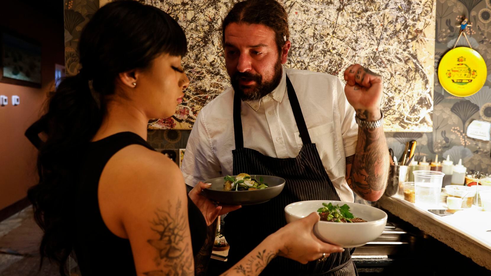 Chef Ross Demers, right, explains an order to restaurant employee Angelica Aguayo on Friday,...