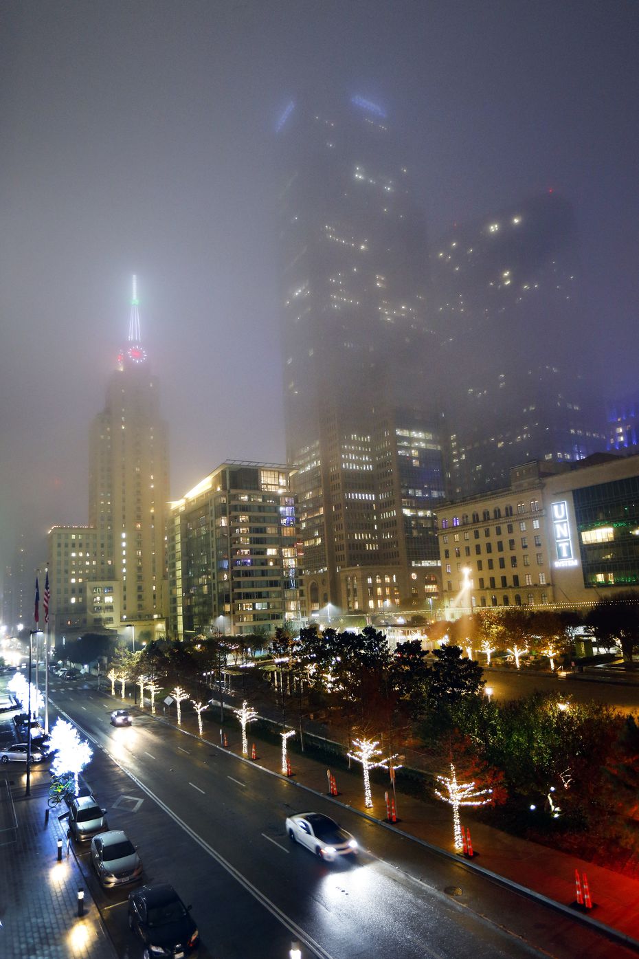 Fog settled over the historic Mercantile Building (left) and Comerica Bank Tower (center)...