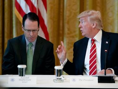 AT&T CEO Randall Stephenson, left, listens as President Donald Trump speaks during the "American Leadership in Emerging Technology" event in the East Room of the White House, Thursday, June 22, 2017, in Washington.