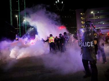 Dallas police tactical officers fired rounds of tear gas at protesters at Young and South...