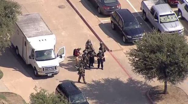 Police officers in armor gathered near Midlothian High School on Sept. 6, 2019 during the course of a lockdown after a threat had been reported at the school.