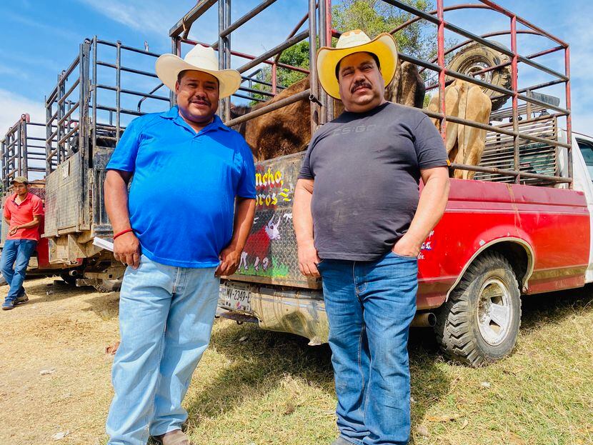 Joaquin Garcia Lopez, left, and his brother Eliel reunite at an outdoor livestock market in...