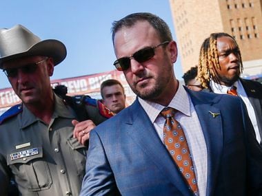 Texas Longhorns head coach Tom Herman greets fans as the team makes their way down Bevo Boulevard prior to a college football game between the University of Texas and Louisiana State University on Saturday, Sept. 7, 2019 at Darrell Royal Memorial Stadium in Austin, Texas.