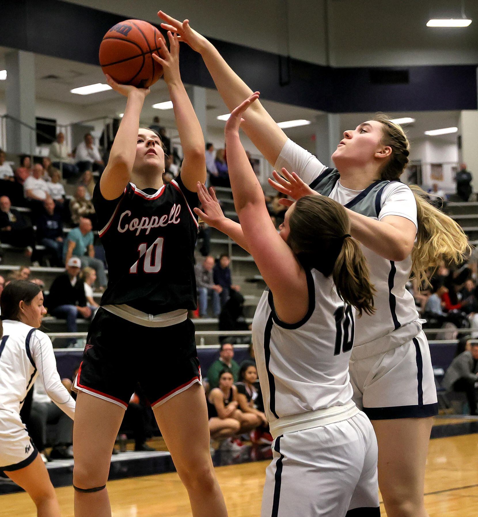 Coppell guard Landry Sherrer (10) tries to get off a shot over Flower Mound guard Madison...