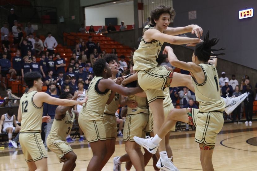 Plano East players Rachard Angton (1), right,  and Ethan Moss (5) leap in celebration as...