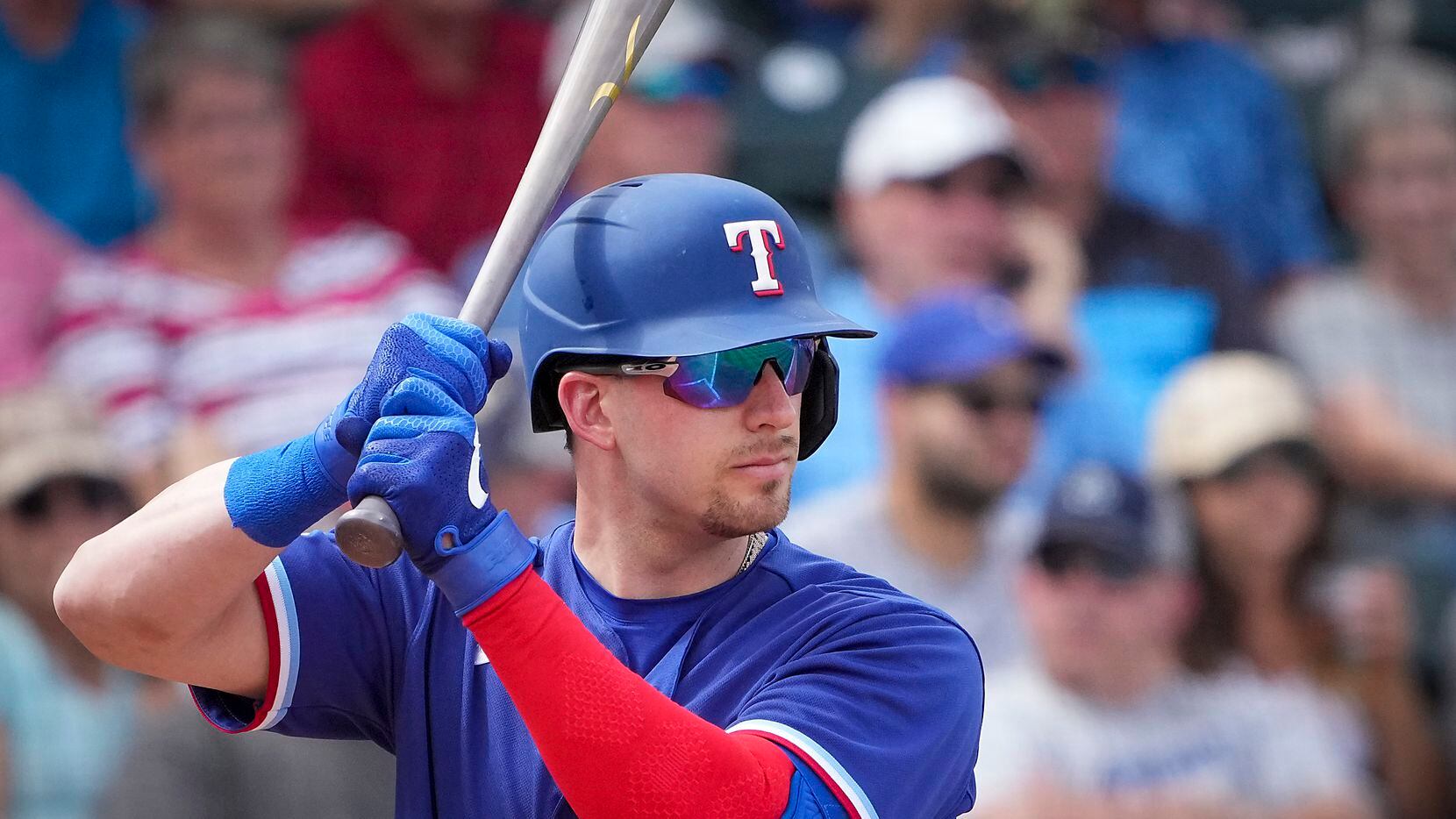 Texas Rangers catcher Mitch Garver bats during the fourth inning of a spring training game...