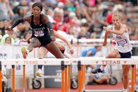 Frisco Panther Creek's Falyn Lott, left, clears a hurdle enroute to her 2nd place finish in...