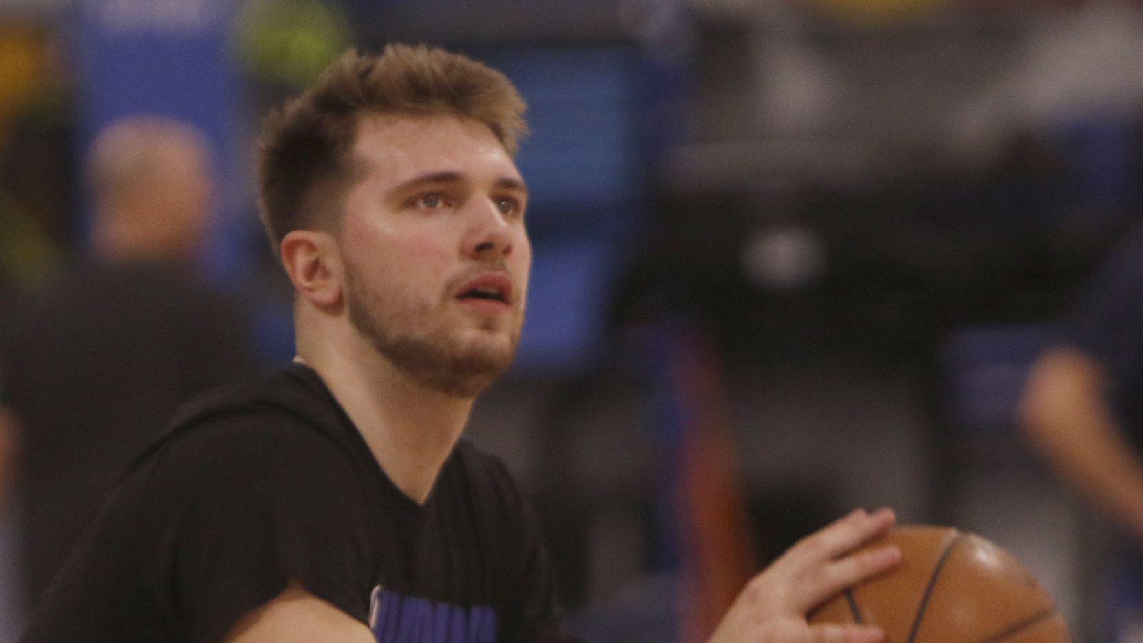Luka Doncic sizes up a shot on his first day back to practice with teammates since sidelined...