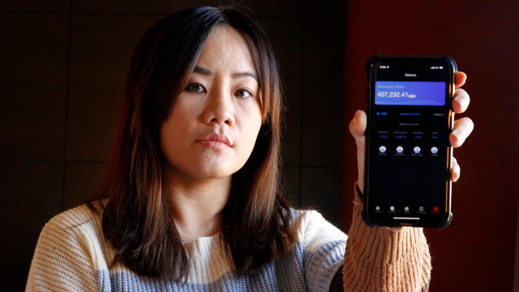 Yik Li of Carrollton shows a screenshot of the value of her crypto account, which rose in...