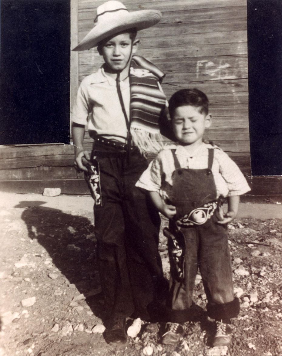 Eleven-year-old Trini Lopez (left) and his brother, Jesse Lopez, 5, pose for a photo in their Western wear in Dallas' Little Mexico. 