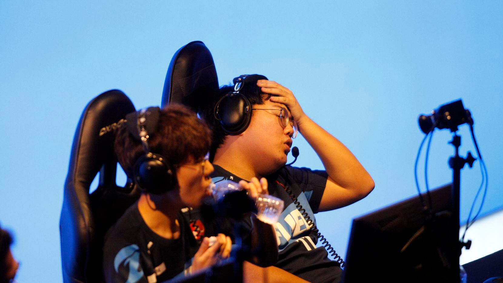 Dallas Fuel's Choi "Hanbin" Han-been, center, reacts after the team lost its 3rd straight...