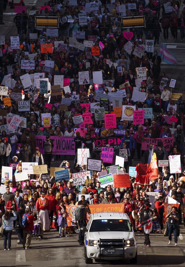 Participants in the 2020 Dallas Women's March walk along Harwood Street on their way to a rally at Dallas City Hall on Sunday, Jan. 19, 2020, in Dallas.