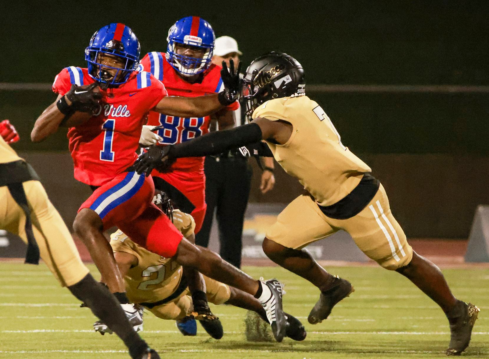 Duncanville High School Lontrell Turner (1) avoids a tackle by South Oak Cliff High School...