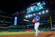 Texas Rangers designated hitter Wyatt Langford heads to the plate during the ninth inning of...
