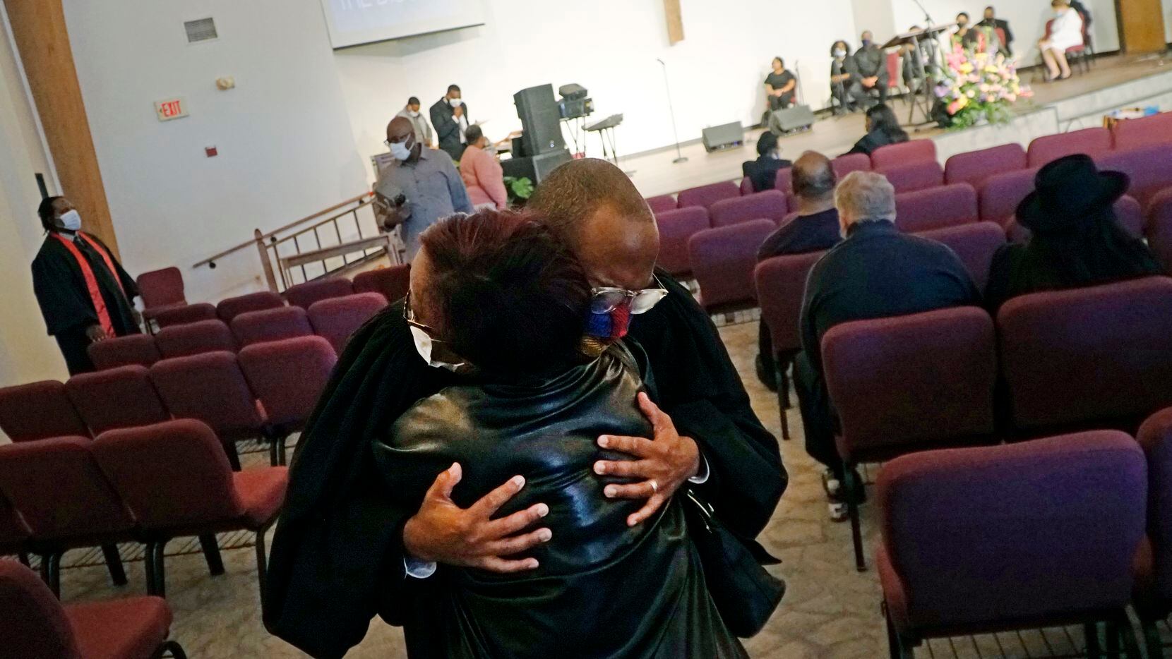Pastor Bryant Phelps hugs Iva Culberson last Sunday before Church of the Disciple United...