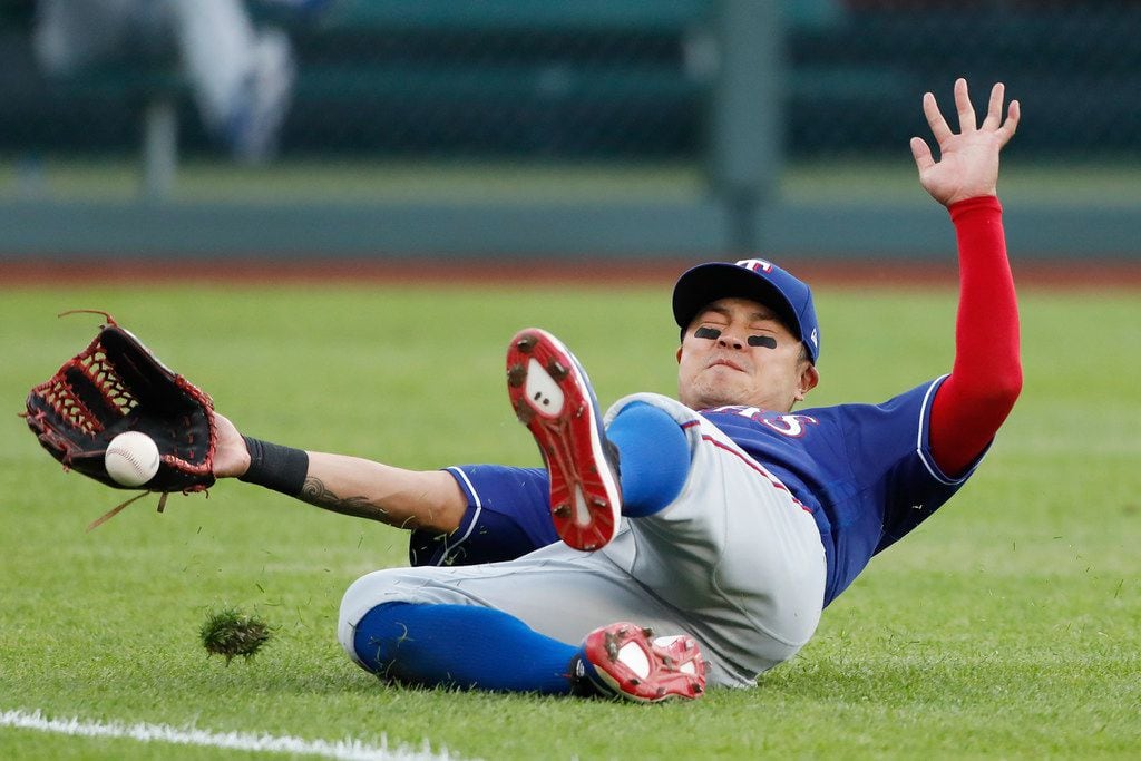 Texas Rangers left fielder Shin-Soo Choo is unable to catch a fly ball hit by Kansas City...