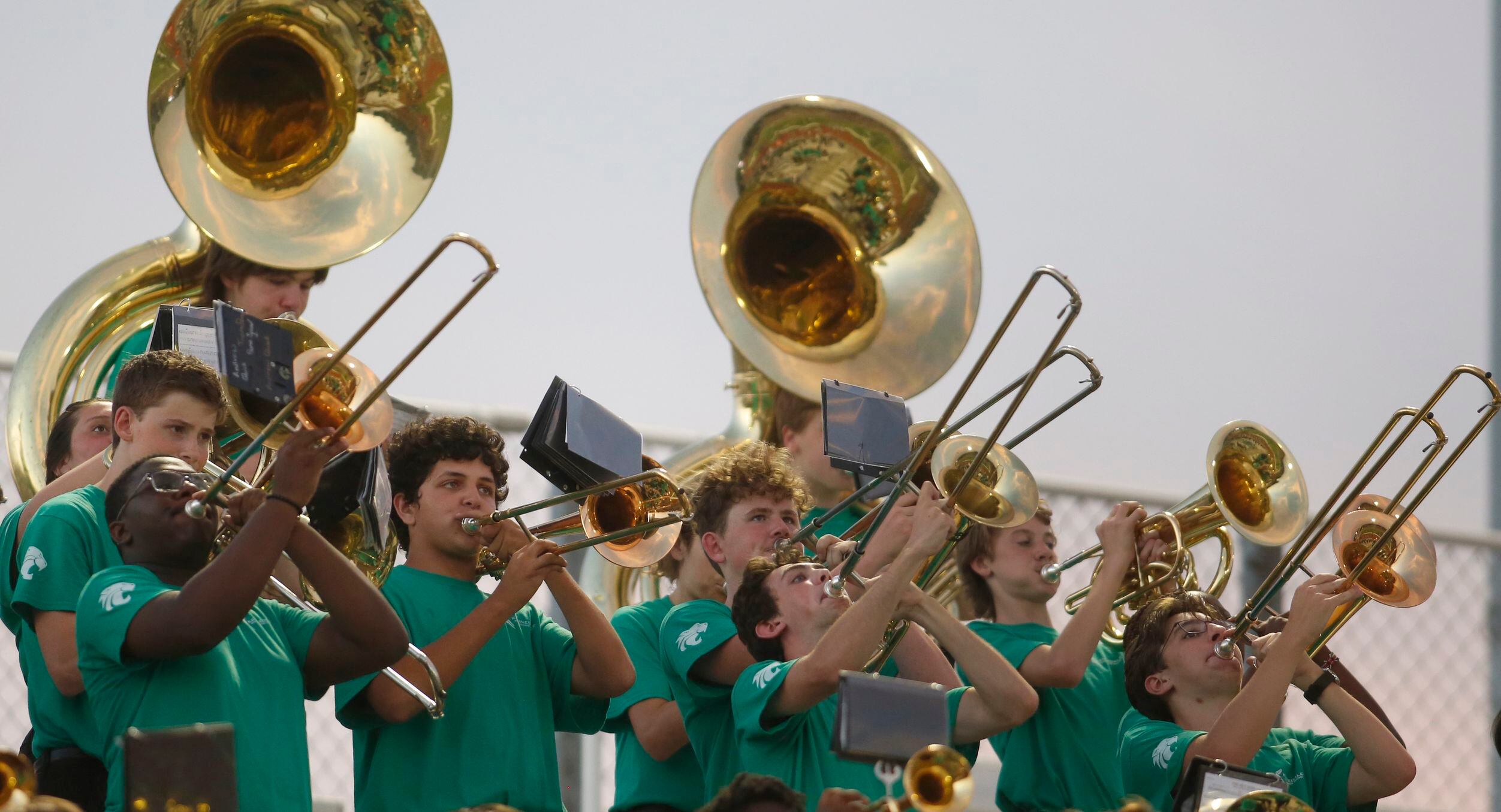 Members of the brass section of the Kennedale band perform from the stands during first half...