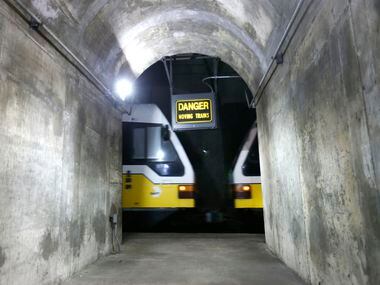 A DART train whizzes past a maintenance tunnel near the unfinished Knox Street station 80...