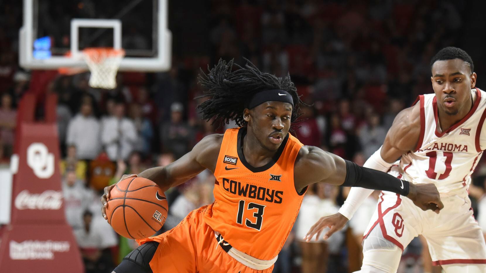 FILE  - In this Feb. 1, 2020, file photo, Oklahoma St. guard Isaac Likekele, left, pushes...