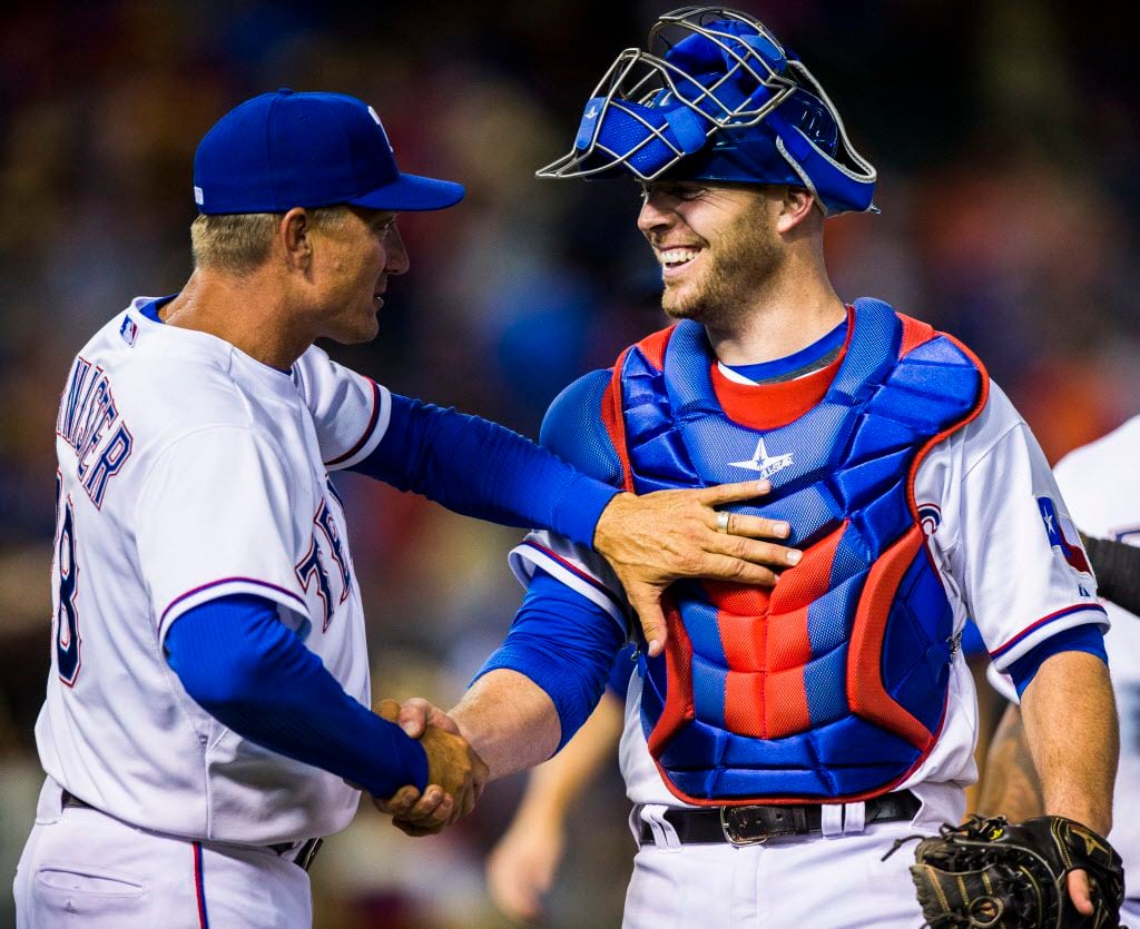Texas Rangers manager Jeff Banister (28) shakes the hand of Texas Rangers catcher Chris...