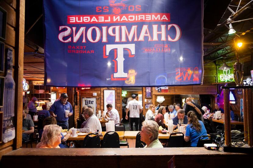 A Texas Rangers American League Champions flag on display as customers eat lunch at J....