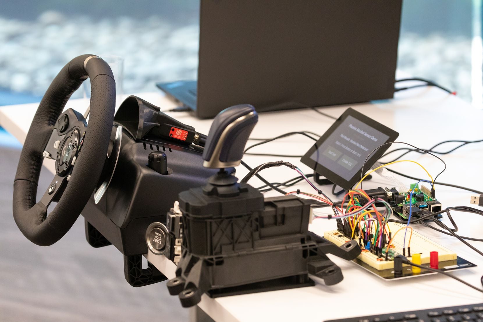 A gaming steering wheel, along with Toyota and Lexus parts, pieced together to create a...