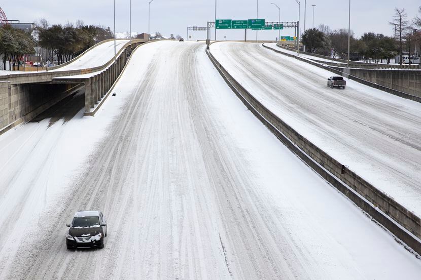 Snow covers Woodall Rodgers Freeway in Downtown Dallas on Monday.