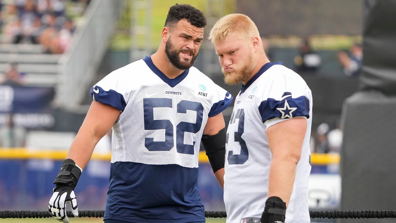 Dallas Cowboys guard Connor Williams (52) and center Tyler Biadasz (63) stretch during a practice at training camp on Sunday, July 25, 2021, in Oxnard, Calif.