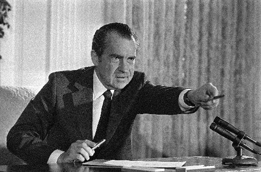  President Richard Nixon offers a souvenir pen to one of those in attendance, Dec. 23, 1971,...