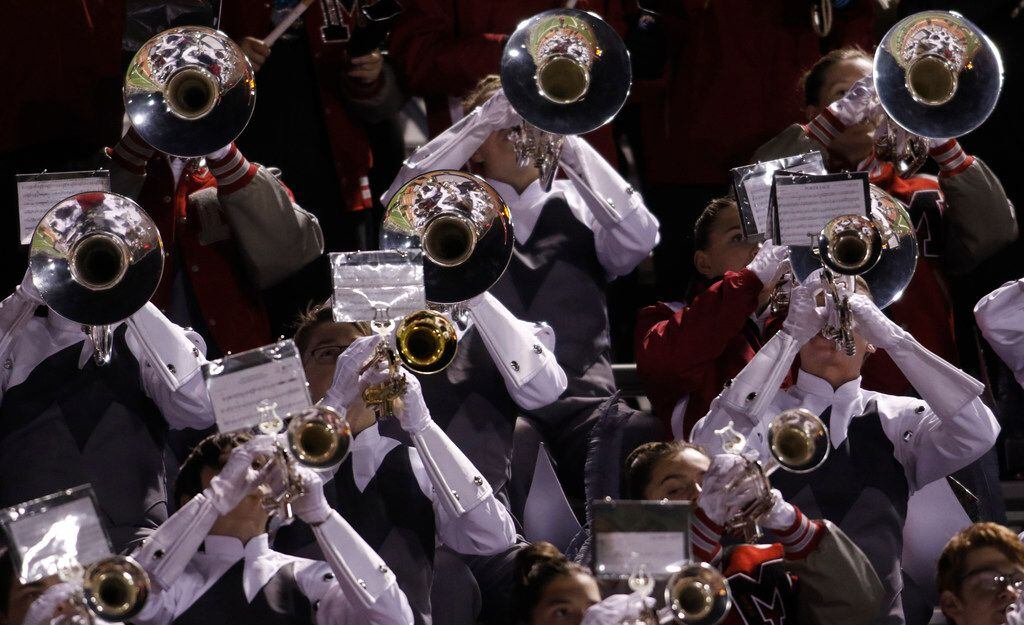 Members of the Flower Mound Marcus band perform from the stands during the first half of the...
