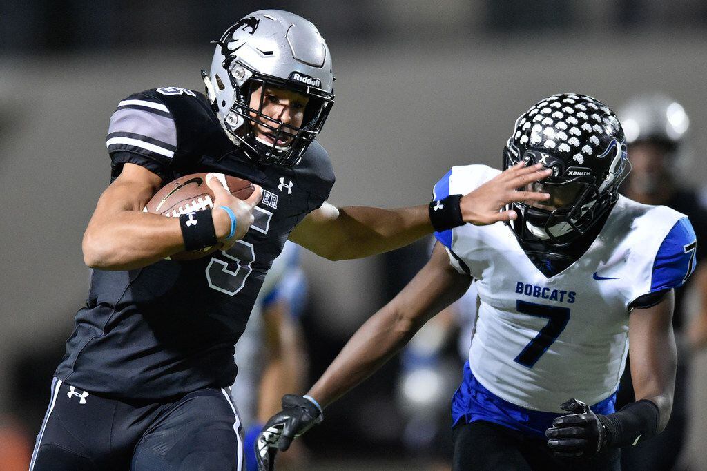 Guyer quarterback Eli Stowers (5) rushes the ball and stiff-arms Nelson's Manace Kabongo (7)...
