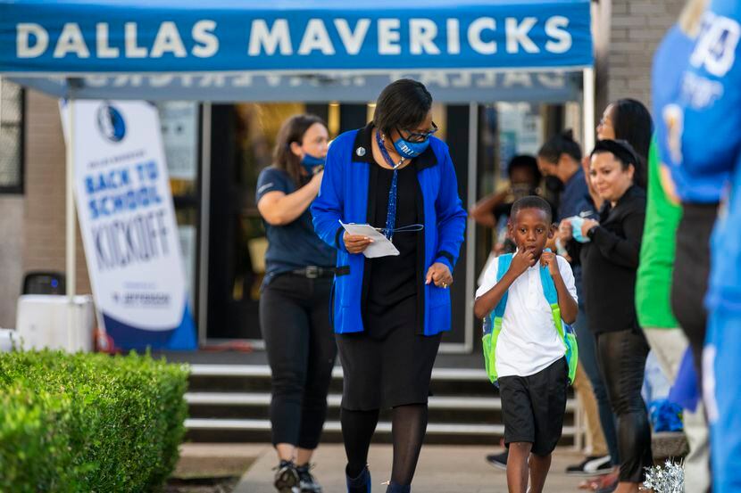 Dallas Mavericks CEO Cynt Marshall welcomes first-grader Gzia Williams, 6, to the first day...