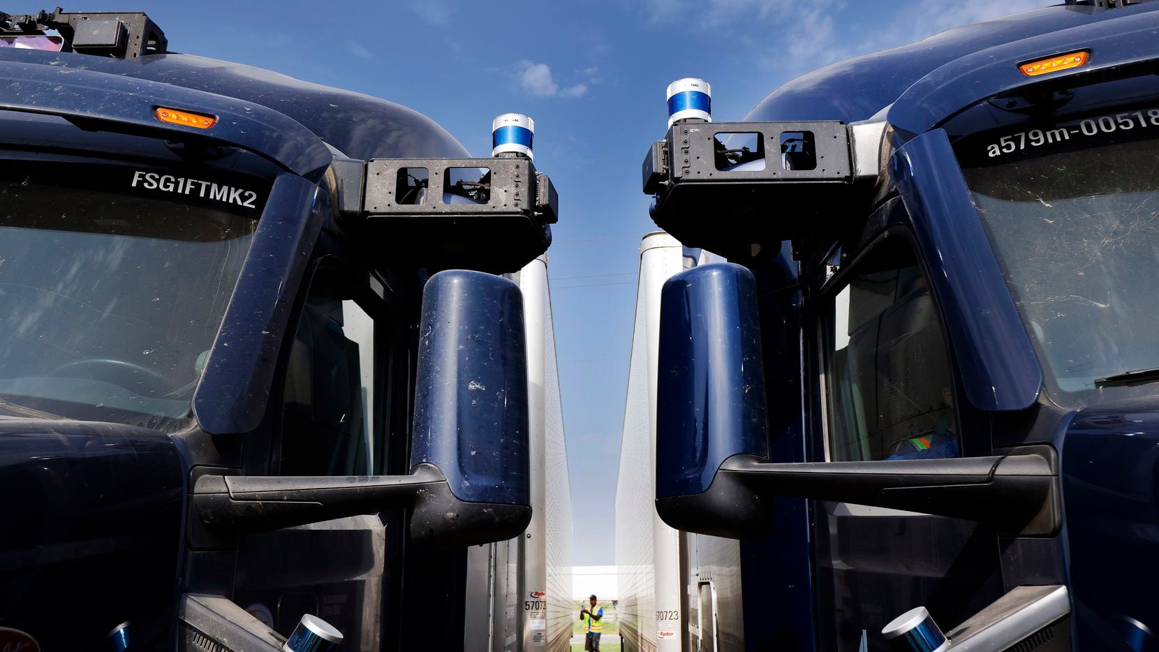 Aurora Truck Operations Specialist Charles Griffin takes photos of an autonomous semi...