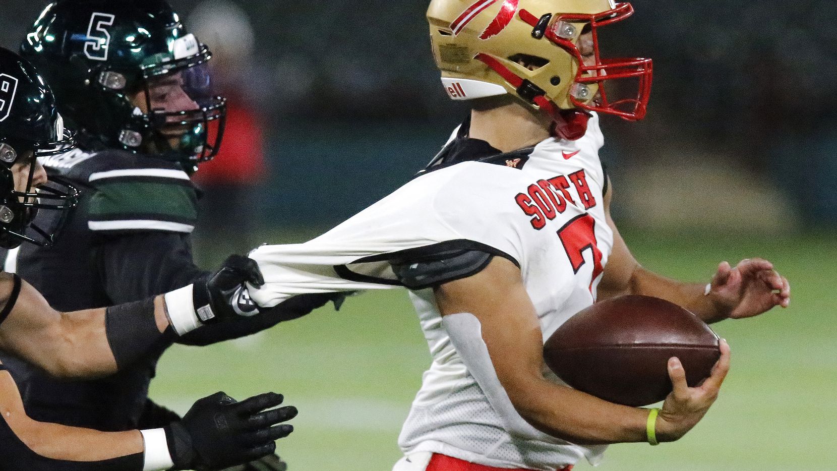 South Grand Prairie High School quarterback Jaden Stanley (7) has his jersey stretched by...