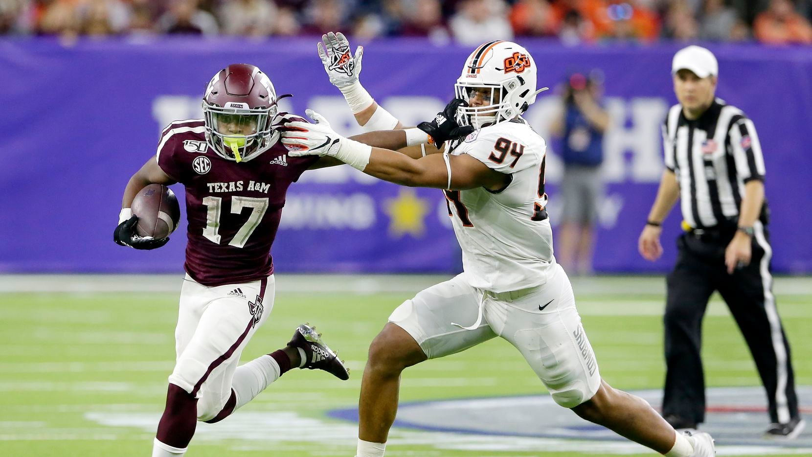 Texas A&M wide receiver Ainias Smith (17) fends off Oklahoma State defensive end Trace Ford (94) during the first half of the Texas Bowl NCAA college football game Friday, Dec. 27, 2019, in Houston.